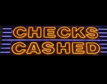 A neon sign says 'Checks Cashed'